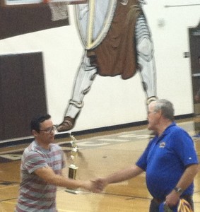 Coach Garcia is presented the trophy.